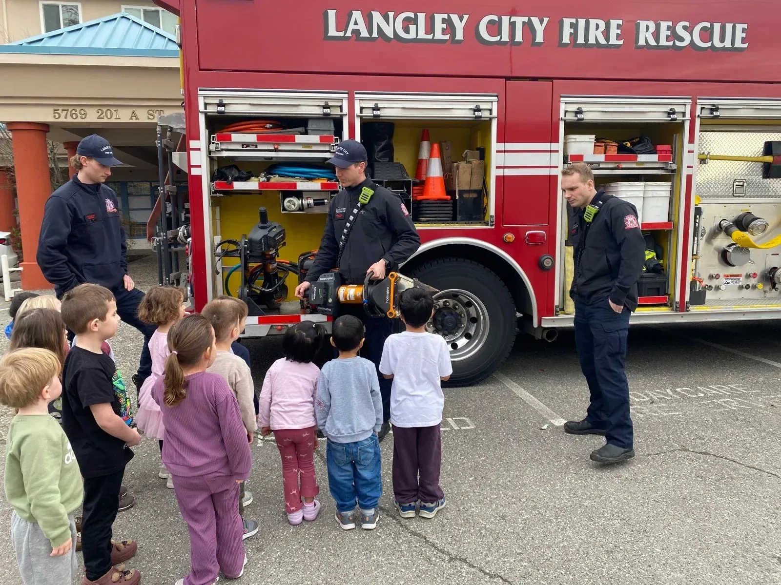 Children gathered around Langley City Fire Rescue firefighters and their fire engine