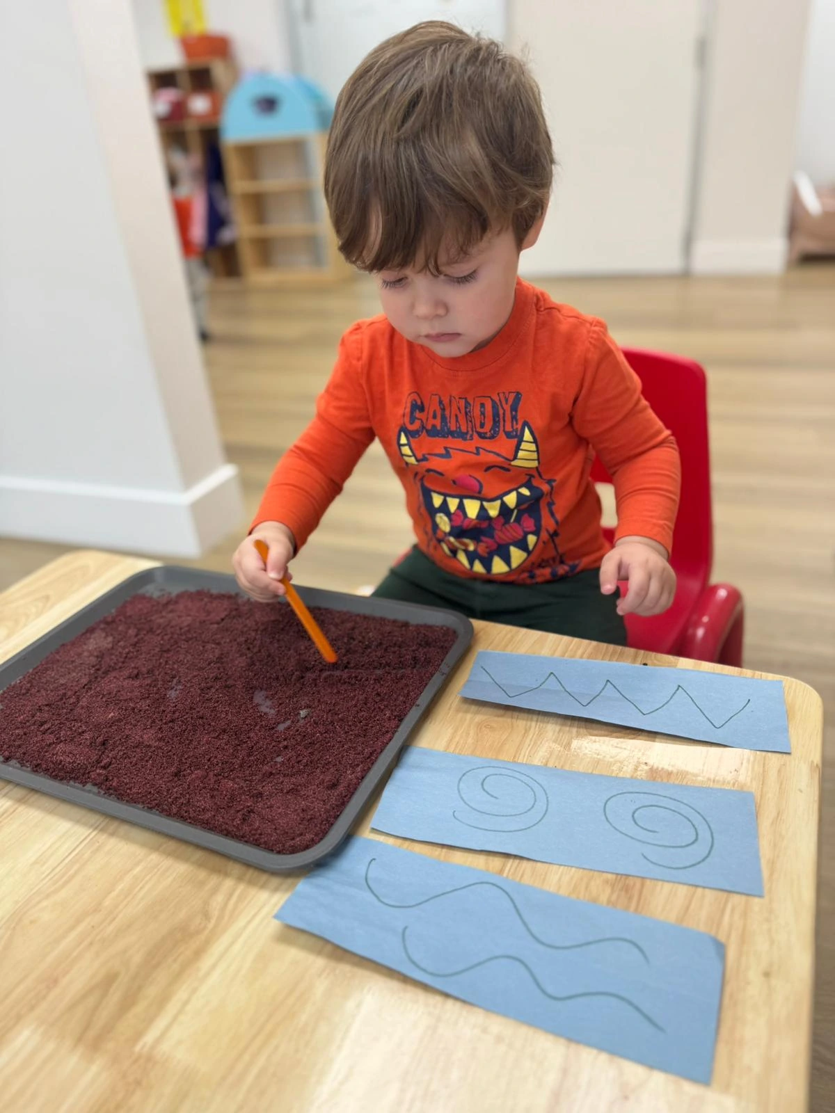 A child exploring mathematical patterns and shapes through tactile sensory materials